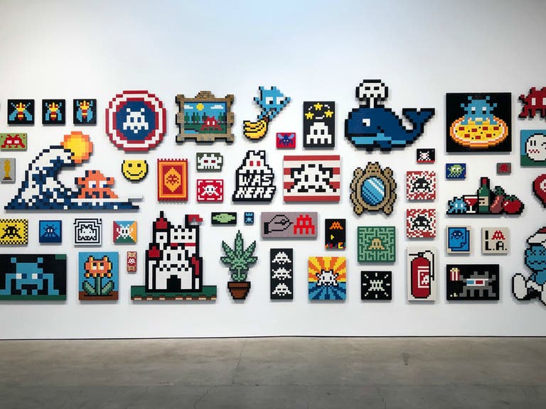 Wall of aliases by Invader at "Into the White Cube" | Photo by Daniel Djang 